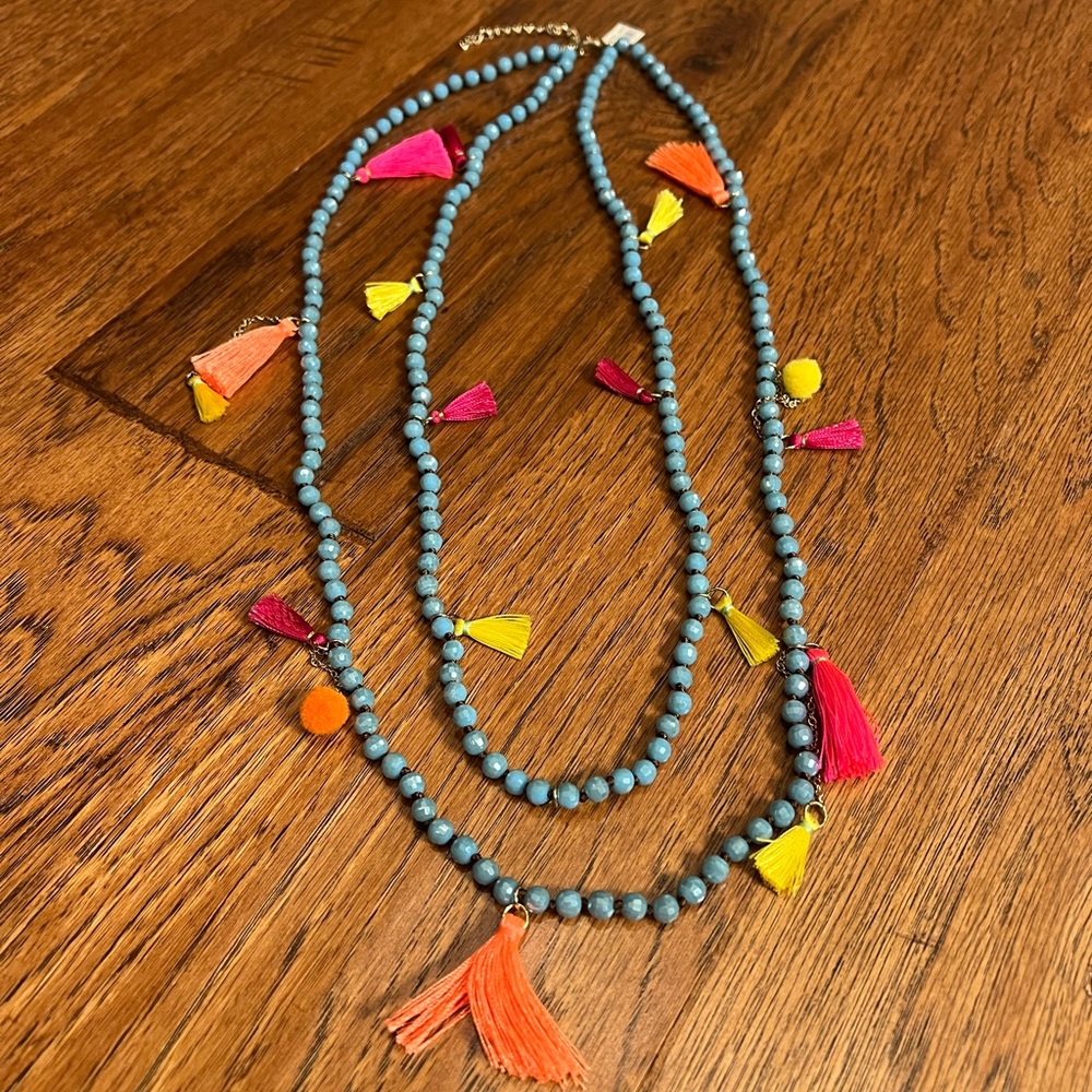 Colorful blue necklace with yellow, orange, pink and red accents